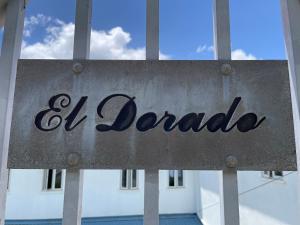 a sign that reads o duboda in front of a window at El Dorado Guest Suites & Car Rental in Roseau +11 photos