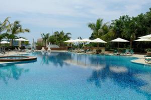 a large swimming pool with chairs and umbrellas at Azul Ixtapa Grand All Inclusive Suites - Spa & Convention Center in Ixtapa