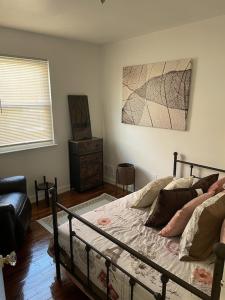 a bedroom with a bed and a dresser in it at Cozy 2 Bedroom, Minutes from Capitol Hill in Washington