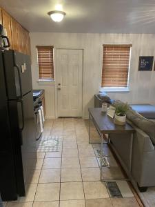 a kitchen with a couch and a table and a refrigerator at Cozy 2 Bedroom, Minutes from Capitol Hill in Washington