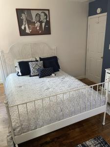 a bedroom with a white bed with pillows on it at Cozy 2 Bedroom, Minutes from Capitol Hill in Washington