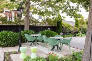 a patio with tables and chairs and a street light at Milano Motor Lodge in Christchurch