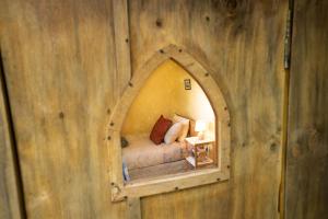 a bedroom with a mirror in a wooden wall at Ao Marama Retreat in Collingwood