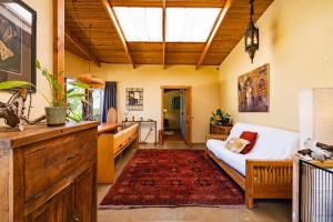 a living room with a couch and a table at Ao Marama Retreat in Collingwood