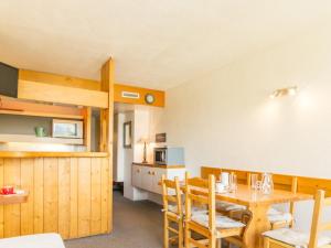 a dining room and kitchen with a table and chairs at Studio Les Arcs 1800, 1 pièce, 5 personnes - FR-1-346-425 in Arc 1800