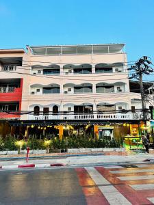 a large white building with a street in front of it at Lime Hotel in Patong Beach