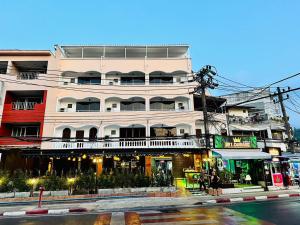 a building on the side of a street with a street at Lime Hotel in Patong Beach