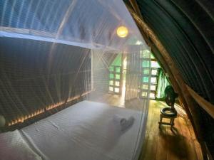 an overhead view of a room with a bed in a house at Los Almendros Palomino Hostel in Palomino