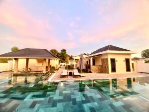 a villa with a swimming pool in a resort at LAM BUNGALOW Resort & Spa in Phu Quoc