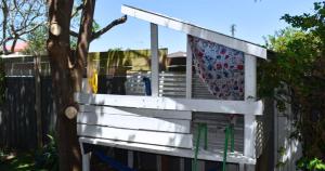 a white wooden bench next to a fence at Discover Booker Bay - Central Coast Family Getaway in Booker Bay +16 photos