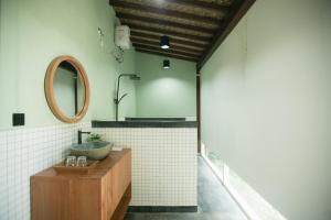 a bathroom with a sink and a mirror at LAYANA FARMSTAY in Banyuwangi
