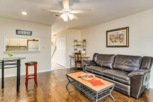 a living room with a leather couch and a table at Bayside Manor near Airport & Beaches in Pensacola