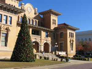 a christmas tree in front of a large building at Bayside Manor near Airport & Beaches in Pensacola