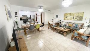 a living room with a couch and a table at Sunny Caribbean Apartment with Pool in Punta Cana