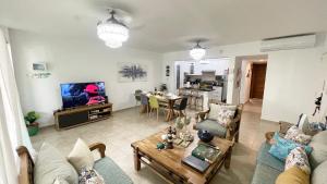 a living room with a couch and a table at Sunny Caribbean Apartment with Pool in Punta Cana