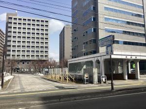 a bus stop on the side of a city street at Sapporo International Youth Hostel in Sapporo