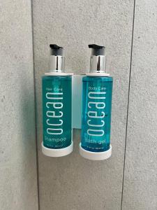 two bottles of shampoos are sitting on a wall at Red Flamboyan Guesthouse and Restaurant in Rincon