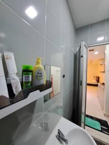 a bathroom with a sink and a mirror at Rest And Go Homestay in Shah Alam