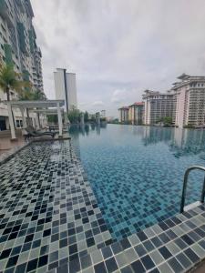 a swimming pool in a city with buildings at Rest And Go Homestay in Shah Alam