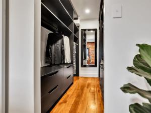 a kitchen with black cabinets and a hardwood floor at The Wool Store in Bathurst