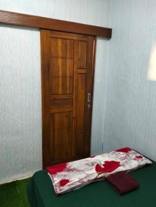 a room with a door and a bed with a blanket at Nio Homestay and Tour in Licin +287 photos