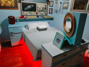 a toy bedroom with a bed and a mirror at The Oasis on Eisenhower in Loveland