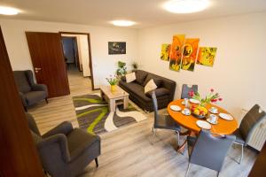 a living room with a table and a couch at Ferienwohnung Tukan Apartment Dresden Laubegast WLAN TV Ebike in Dresden