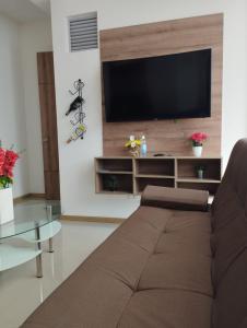Il comprend un salon doté d'un canapé et d'une télévision à écran plat. dans l'établissement Hermoso Condominio Vacacional Paraiso del Sol, à San Jerónimo