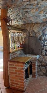 a stone kitchen with a counter with wine glasses at Holiday home in Drganja sela Kranjska Krain 42002 in Drganja Sela