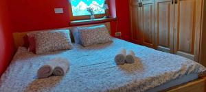 a bed with two pairs of slippers and towels on it at Holiday home in Drganja sela Kranjska Krain 42002 in Drganja Sela