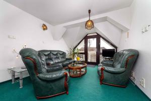 a living room with two leather chairs and a table at House and Apt in Balatonboglar 42692 in Balatonboglár