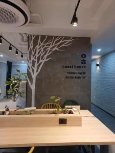 a meeting room with a tree mural on the wall at Aha Stay in Gyeongju