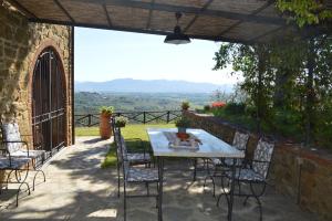 a table and chairs on a patio with a view at Holiday home in Arezzo - Toskana 39940 in Arezzo