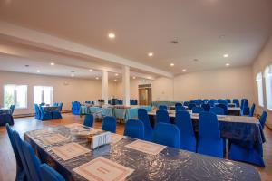 a banquet hall with blue tables and blue chairs at Cavendish Memotree Resort in Cavendish +67 photos