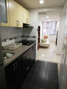 a kitchen with a sink and a counter top at Funza Apartamento Normandia del Parque II in Funza
