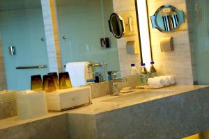 a bathroom counter with two sinks and a mirror at Renaissance Suzhou Wujiang Hotel in Suzhou