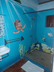 a room with a sea turtle wall mural at Villa Paradis in Sainte Marie