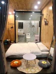 a room with two beds and a sink and a bathroom at Nhà Bắp in Da Lat