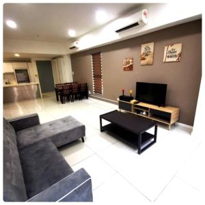 a large living room with a couch and a tv at reSTARY - K-Box, Sutera Avenue Infinity Pool - Imago Opposite - KK City- 2BR,6Pax 来沙旅 K房主题公寓 - 无边际日落海景泳池 - Imago商场对面 - KK市中心 - 2房6人 in Kota Kinabalu