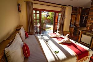 a bedroom with a bed with two swans on it at Havana Beach Resort Phangan in Thong Nai Pan Yai