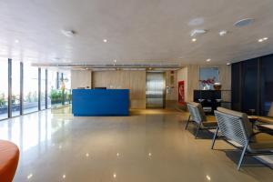 an office lobby with chairs and a blue counter at Benjarong Hotel Bangkok in Ban Zong Katiam