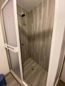 a shower with a glass door in a bathroom at Departamento familiar en Ensenada in Ensenada