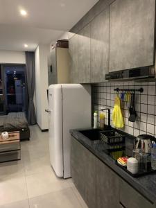 a kitchen with a white refrigerator in a room at 21B No.1 Best Location In Phnom Penh Capital, Swimming Pool & Gyms in Phnom Penh