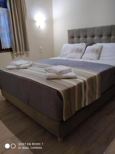 a bed with two pillows on it in a room at Menelaos Apartments in Lefokastro