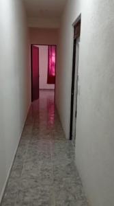 an empty room with a hallway with two doors at Departamentos La Angosta in Acapulco