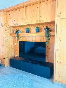 a living room with a fireplace with wooden walls at Wellness-Apartment Seefeld and Chill SPA im Zentrum mit Pool, Sauna und Netflix for free in Seefeld in Tirol