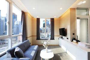 ソウルにあるThe Stay Classic Hotel Myeongdongのリビングルーム(青いソファ、大きな窓付)