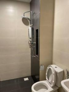 a small bathroom with a toilet and a shower at Pacific Tower PJ Section 13 WifiParkingOppJayaOne Mall in Petaling Jaya