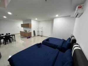 a bedroom with a blue bed and a dining room at Pacific Tower PJ Section 13 WifiParkingOppJayaOne Mall in Petaling Jaya