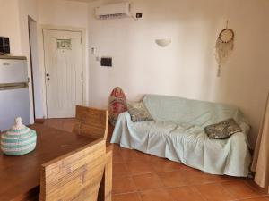 a living room with a couch and a table at Beach front ocean view Porto Antigo2 Santa Maria in Santa Maria